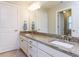 A double vanity with granite countertop, undermount sinks, framed mirror, and vanity lighting at 354 Crimson Way, Pittsboro, NC 27312