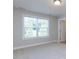 Bright bedroom with plush carpet, a large window with blinds, and white doors and trim at 354 Crimson Way, Pittsboro, NC 27312