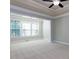 Bedroom with a large window and neutral carpet, with the entrance to a sitting room at 354 Crimson Way, Pittsboro, NC 27312