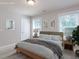 Cozy bedroom featuring neutral decor, large windows, and comfortable furnishings creating a relaxing atmosphere at 354 Crimson Way, Pittsboro, NC 27312