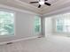 Light-filled bedroom with a large window and neutral carpet, with the entrance to a sitting room at 354 Crimson Way, Pittsboro, NC 27312