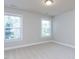 Bright bedroom with neutral walls, trim and carpet and 2 windows providing ample natural light at 354 Crimson Way, Pittsboro, NC 27312