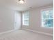 Bright bedroom with neutral walls, trim and carpet and 2 windows providing ample natural light at 354 Crimson Way, Pittsboro, NC 27312