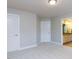 Neutral bedroom featuring plush carpet, white doors and trim, and access to a bathroom at 354 Crimson Way, Pittsboro, NC 27312