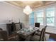 Staged dining room featuring decorative chandelier, tray ceiling, and neutral palette at 354 Crimson Way, Pittsboro, NC 27312