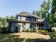 Exterior of a blue two-story home with a screened porch, well-maintained lawn, and mature trees at 354 Crimson Way, Pittsboro, NC 27312