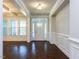 Elegant foyer with hardwood floors, wainscoting, and natural light streaming through the front door at 354 Crimson Way, Pittsboro, NC 27312