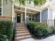 Inviting front porch featuring brick steps and tasteful landscaping, enhancing curb appeal at 354 Crimson Way, Pittsboro, NC 27312