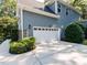 Attached two-car garage with an extended driveway and manicured landscaping at 354 Crimson Way, Pittsboro, NC 27312