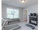 Home gym featuring a treadmill, free weights, medicine balls, and a large window for natural light at 354 Crimson Way, Pittsboro, NC 27312
