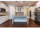 Well-equipped kitchen features granite countertops, stainless steel appliances, and a center island with pendant lighting at 354 Crimson Way, Pittsboro, NC 27312
