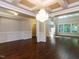 The spacious living room features elegant lighting, wainscoting, and a high ceiling at 354 Crimson Way, Pittsboro, NC 27312