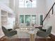 Bright living room featuring a high ceiling, built-in shelving, and ample seating at 354 Crimson Way, Pittsboro, NC 27312