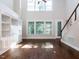 Bright living room featuring a high ceiling, built-in shelving, and hardwood floors at 354 Crimson Way, Pittsboro, NC 27312
