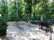 Backyard patio featuring a stone fire pit, grill, and seating area, perfect for outdoor gatherings at 354 Crimson Way, Pittsboro, NC 27312