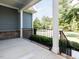 This outdoor porch shows the backyard with a wrought iron railing around the perimeter at 354 Crimson Way, Pittsboro, NC 27312