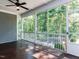 Spacious screened porch with wood flooring and views of the surrounding wooded landscape at 354 Crimson Way, Pittsboro, NC 27312
