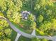Aerial view of a house with well-manicured landscaping surrounded by lush trees at 3650 Pleasants Ridge Dr, Wake Forest, NC 27587
