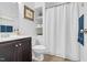 Well-lit bathroom featuring a shower with curtain, dark wood vanity, and modern fixtures at 3650 Pleasants Ridge Dr, Wake Forest, NC 27587
