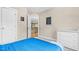 Bedroom showcases blue bedding, wall art, and an open doorway leading to the home's second level at 3650 Pleasants Ridge Dr, Wake Forest, NC 27587
