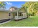 View of the house's covered patio with string lights, a white railing, and a ceiling fan at 3650 Pleasants Ridge Dr, Wake Forest, NC 27587