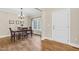 Cozy dining room with hardwood floors, chandelier, and natural light from the window at 3650 Pleasants Ridge Dr, Wake Forest, NC 27587