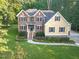 Beautiful two-story home with brick and vinyl siding and lush green landscaping at 3650 Pleasants Ridge Dr, Wake Forest, NC 27587