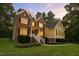 Charming two-story brick and yellow-sided home with a manicured front lawn at 3650 Pleasants Ridge Dr, Wake Forest, NC 27587