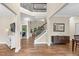 Inviting foyer featuring hardwood floors, a staircase, and an open view of the living space at 3650 Pleasants Ridge Dr, Wake Forest, NC 27587