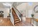 Open foyer with hardwood floors and staircase leads to a view of the dining room at 3650 Pleasants Ridge Dr, Wake Forest, NC 27587