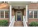 Close-up of a brick home's front door with a decorative wreath and manicured landscaping at 3650 Pleasants Ridge Dr, Wake Forest, NC 27587