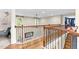 View of the upstairs hallway overlooking the living room with wood floors and wood banisters at 3650 Pleasants Ridge Dr, Wake Forest, NC 27587