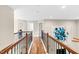 View of the upstairs hallway with hardwood floors, art, and white doors at 3650 Pleasants Ridge Dr, Wake Forest, NC 27587