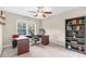 Home office featuring a traditional desk setup, ample natural light, and a built-in bookcase at 3650 Pleasants Ridge Dr, Wake Forest, NC 27587