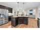 An open kitchen area features granite countertops, a kitchen island, and stainless steel appliances at 3650 Pleasants Ridge Dr, Wake Forest, NC 27587