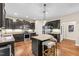 A spacious kitchen is shown with dark cabinets, granite countertops, stainless steel appliances, and a kitchen island at 3650 Pleasants Ridge Dr, Wake Forest, NC 27587