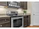 A kitchen is shown with stainless steel appliances and dark cabinets at 3650 Pleasants Ridge Dr, Wake Forest, NC 27587