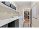A functional laundry room is showcased with shelving, a folding table, and appliances at 3650 Pleasants Ridge Dr, Wake Forest, NC 27587