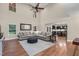 Spacious living room with hardwood floors, modern furnishings, and an open floor plan to the kitchen at 3650 Pleasants Ridge Dr, Wake Forest, NC 27587