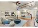Open-concept living room with hardwood floors, modern decor, and access to the second-story balcony at 3650 Pleasants Ridge Dr, Wake Forest, NC 27587