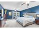 Spacious main bedroom featuring blue walls, carpet, ceiling fans, and a large bed at 3650 Pleasants Ridge Dr, Wake Forest, NC 27587