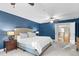 Spacious main bedroom featuring blue walls, carpet, ceiling fans, and a large bed at 3650 Pleasants Ridge Dr, Wake Forest, NC 27587
