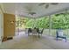 Spacious covered patio with outdoor seating, fans, and peaceful backyard views at 3650 Pleasants Ridge Dr, Wake Forest, NC 27587
