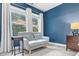 Main bedroom sitting area with large windows, love seat, and side table at 3650 Pleasants Ridge Dr, Wake Forest, NC 27587