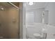 Bright bathroom featuring a glass shower door, toilet, and window that provides natural light at 3812 Vesta Dr, Raleigh, NC 27603