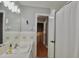 Well-lit bathroom featuring a tiled sink, vanity, and a shower with a curtain at 3812 Vesta Dr, Raleigh, NC 27603