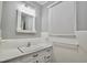 Well-lit bathroom featuring a tiled sink and vanity, with a window providing natural light at 3812 Vesta Dr, Raleigh, NC 27603