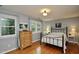 Inviting bedroom with hardwood floors, a bed, and two large windows with serene views at 3812 Vesta Dr, Raleigh, NC 27603