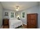Comfortable bedroom with neutral tones, natural light, and hardwood floors at 3812 Vesta Dr, Raleigh, NC 27603