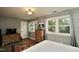 Bright bedroom with hardwood floors, natural light, and a dresser providing ample storage at 3812 Vesta Dr, Raleigh, NC 27603
